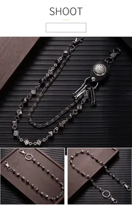 Detailed view of dark punk style metal wallet chain with silver dice charms.