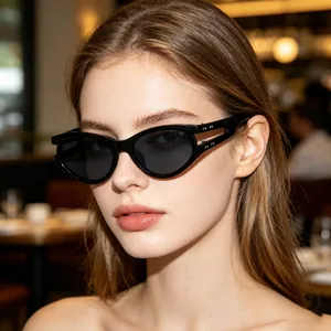 Close-up of a model wearing trendy black oval sunglasses in an outdoor setting