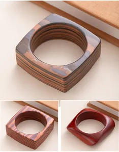 Close-up of retro square wooden bangles with natural wood grain textures.