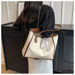 Stylish large cream and brown leather tote bag with decorative silk scarf for women