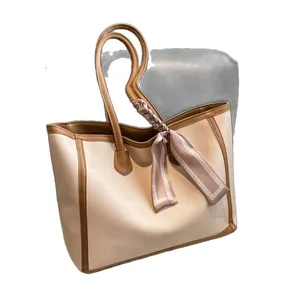 Elegant cream large capacity tote bag with brown trim and decorative silk scarf accessory