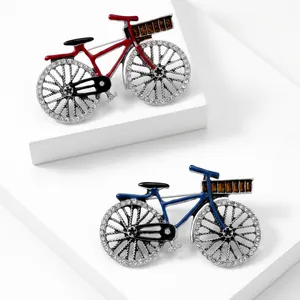 Detailed view of vintage bicycle brooches featuring sparkling crystals and amber-colored stones