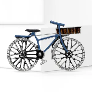 Detailed view of a vintage blue bicycle brooch with sparkling rhinestone wheels.