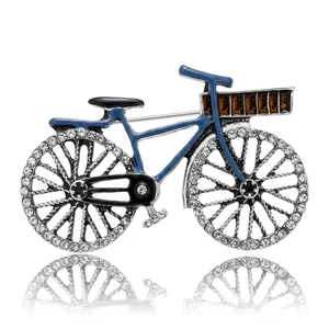 Elegant vintage blue bicycle brooch featuring rhinestone wheels and a brown crystal basket.