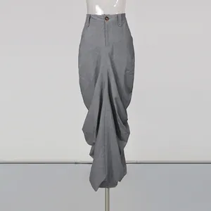 Detail shot of an elegant grey pleated midi skirt with unique draping design.
