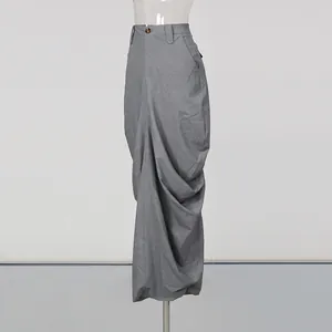 Detailed view of a grey high-waisted pleated maxi skirt featuring elegant draping.