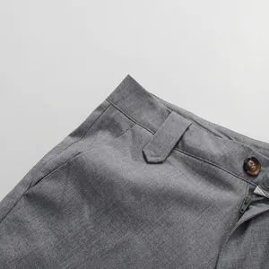 Close-up detail of grey elegant straight skirt with premium button and zipper closure