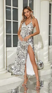 Full-length view of a silver sequin halter evening gown with a high side slit design