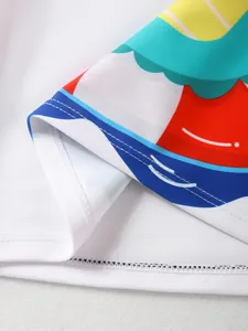 Detailed view showing quality stitching and vibrant cartoon print on white kids swimwear