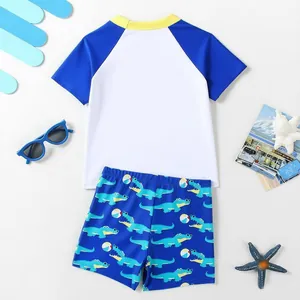 Two-piece boys' swimsuit with cartoon crocodile print and short sleeves