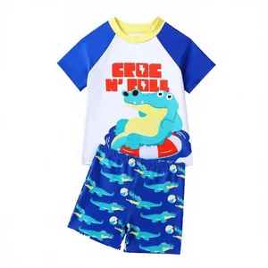 Boys two-piece cartoon crocodile swim set with short sleeve rash guard and shorts.