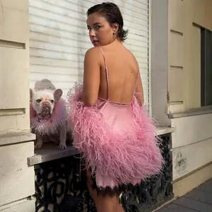 Chic pink satin mini dress with luxury ostrich feather trim and elegant open back design