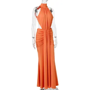 Detailed view of an elegant orange backless mermaid evening gown for banquets.