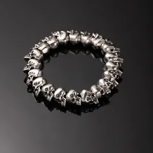 Vintage gothic punk style silver skull bead bracelet for men on a black surface