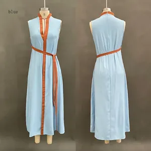 Detail view of a sleeveless blue maxi dress with contrast brown trim and belt