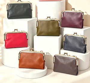 Vintage leather kiss-lock coin purses in various colors displayed on white stands