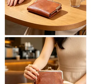 Vintage brown leather kiss-lock wallet shown in a cozy cafe setting