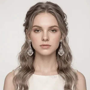 Close-up of elegant silver bridal rhinestone drop earrings worn by a female model