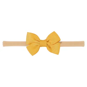 Diadema con lazo de cinta de grosgrain amarilla para bebés con banda elástica de nailon