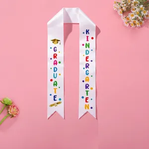 White satin kindergarten graduation sash with colorful 'GRADUATE' print design