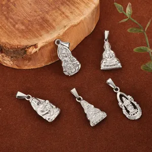 Detailed view of five silver-toned Buddha and Guanyin pendants on textured brown background