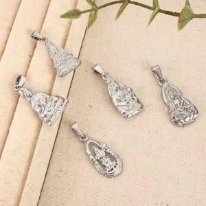 Detailed view of silver-tone Guanyin and Buddha pendants on linen background.