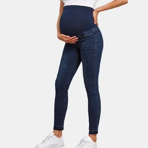 High-waisted maternity skinny jeans with elastic belly support band in dark blue