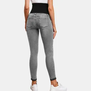 Gray high-waisted maternity skinny jeans with elastic black abdominal support band