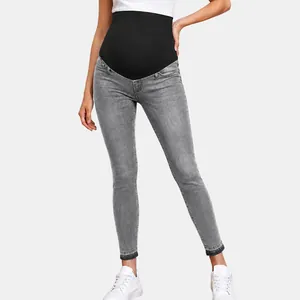 High-waisted maternity skinny jeans with an elastic black belly support band in gray