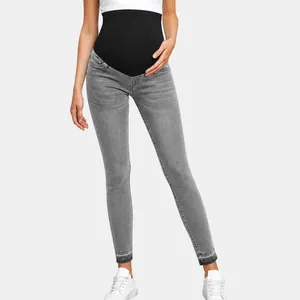 High-waisted maternity skinny jeans with black belly support band in grey denim