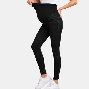 Detailed view of high-waist maternity skinny jeans with elastic belly support band.