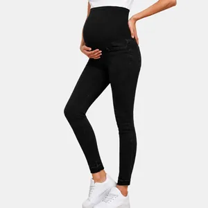 Detail view of black high-waisted maternity skinny jeans with belly band support