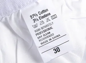 Macro view of men's clothing care label showing 97% cotton material and size 30
