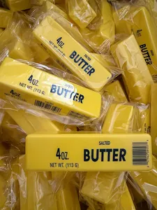 Detailed close-up of a realistic yellow butter stick squishy toy with printed text