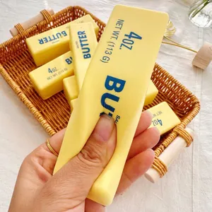 Close-up of yellow butter stick squishy toy showing soft slow rebound texture