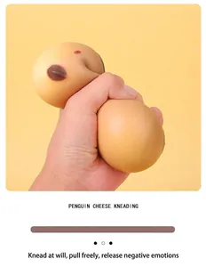 Close-up of a hand squeezing a soft penguin cheese squishy toy for stress relief