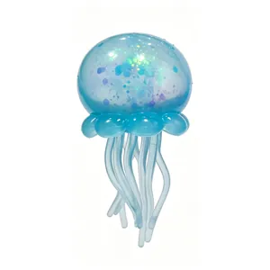 Close-up of translucent blue jellyfish squishy toy with colorful shiny glitters