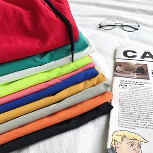 Stack of colorful men's summer casual candy-colored beach shorts in ten shades.
