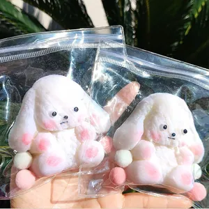 Soft white plush animal squishy toy in clear ziplock packaging