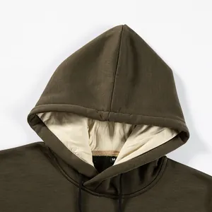 Macro detail view of olive green fleece hoodie showing hood interior and neckline tag