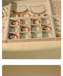 Beige velvet jewelry display trays for organizing necklaces, rings, and bracelets