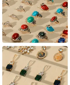 Close-up of beige velvet jewelry display tray with assorted rings and earrings.