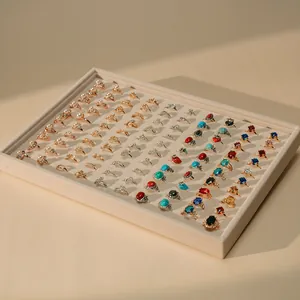 Beige velvet jewelry display tray organizer with multiple rings for store presentation.