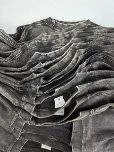 Detailed macro shot of stacked vintage acid-washed cotton t-shirts with ribbed collars
