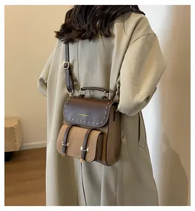 Back view of retro contrast color leather backpack on model in beige trench coat