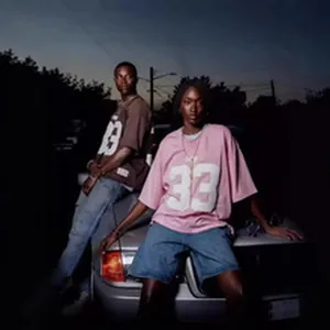 Streetwear lifestyle view of oversized vintage graphic t-shirts in urban night setting