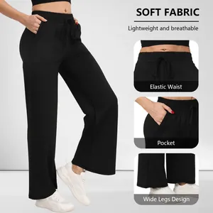 Details van zwarte yogabroek met wijde pijpen, elastische taille en handige zakken.