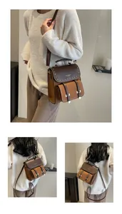 Model wearing a vintage brown two-tone faux leather backpack in an indoor setting