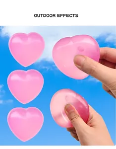 Pink heart-shaped squishy toy showing outdoor color-changing effect in hand