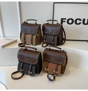 Detailed display of four retro stylish backpacks in multiple colors on white stand.